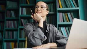 Financier woman glasses on face work stylish office, uses laptop, report to a freelancer company