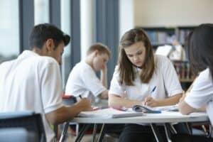 Group of teenagers working in school class